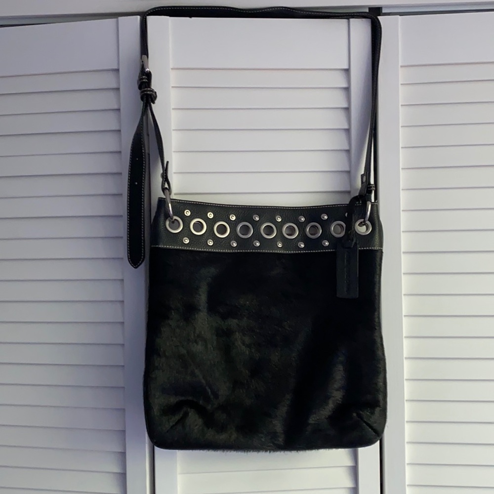 Crossbody with grommets and fox fur.